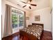 Cozy bedroom with a ceiling fan, large window, and hardwood floors at 4010 Carlton Dr, Claremont, NC 28610