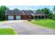 Charming brick home with attached two-car garage, well-maintained lawn, and inviting front porch at 4010 Carlton Dr, Claremont, NC 28610
