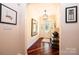 Inviting foyer with hardwood flooring, decorative artwork, an elegant light fixture, and a patterned entry rug at 4010 Carlton Dr, Claremont, NC 28610