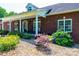 Inviting brick home with a charming front porch, perfect for enjoying the outdoors in comfort at 4010 Carlton Dr, Claremont, NC 28610