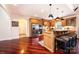 Open kitchen featuring stainless steel appliances, granite countertops, a breakfast bar, and hardwood flooring at 4010 Carlton Dr, Claremont, NC 28610