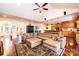 Expansive living room with a vaulted ceiling, hardwood floors, a large leather sectional, and seamless kitchen access at 4010 Carlton Dr, Claremont, NC 28610