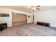 Spacious living room with plush carpeting, ceiling fan, and view to adjacent room at 4010 Carlton Dr, Claremont, NC 28610