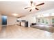 Open floor plan with tile flooring connecting the kitchen and carpeted living area at 4010 Carlton Dr, Claremont, NC 28610