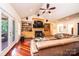 Cozy living room featuring built-in shelving, a fireplace, hardwood floors, and access to the outdoor deck at 4010 Carlton Dr, Claremont, NC 28610