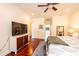 Bright main bedroom featuring wood floors, a ceiling fan, and a large TV at 4010 Carlton Dr, Claremont, NC 28610
