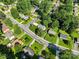 Wide aerial perspective of the property nestled in a residential neighborhood with lush greenery and tree-lined streets at 4101 Tipperary Pl, Charlotte, NC 28215