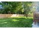 Lush green backyard with a wooden fence, offering privacy and a serene outdoor space at 4101 Tipperary Pl, Charlotte, NC 28215