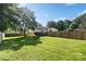 Large, well-maintained backyard with mature trees and a wooden fence, providing a private outdoor retreat at 4101 Tipperary Pl, Charlotte, NC 28215