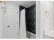 Modern bathroom with black and white patterned walls, and white fixtures at 4101 Tipperary Pl, Charlotte, NC 28215