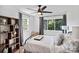 Bedroom featuring a large window with curtains, a ceiling fan, and a decorative bookshelf at 4101 Tipperary Pl, Charlotte, NC 28215