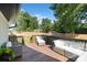Outdoor deck with comfortable seating, surrounded by lush greenery and a privacy fence at 4101 Tipperary Pl, Charlotte, NC 28215