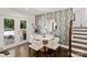 Dining area featuring modern wallpaper, a round table with four chairs, and a door to the backyard at 4101 Tipperary Pl, Charlotte, NC 28215