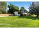 Expansive lush green front lawn with view of renovated home and fenced backyard at 4101 Tipperary Pl, Charlotte, NC 28215