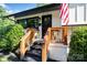 Inviting front porch with black front door, modern house numbers, and wooden railing at 4101 Tipperary Pl, Charlotte, NC 28215