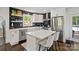 Bright kitchen features white cabinets, stainless steel appliances, tiled backsplash, and kitchen island at 4101 Tipperary Pl, Charlotte, NC 28215