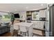 Modern kitchen features white cabinets, subway tile, island with seating, and stainless steel appliances at 4101 Tipperary Pl, Charlotte, NC 28215