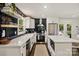 Elegant kitchen boasting white countertops, stainless steel appliances, ample storage, and center island at 4101 Tipperary Pl, Charlotte, NC 28215