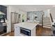 Bright open kitchen features an island, stainless steel appliances, and adjacent dining area at 4101 Tipperary Pl, Charlotte, NC 28215