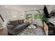 Cozy living room showcasing a comfortable gray sofa, patterned rug, and ample natural light at 4101 Tipperary Pl, Charlotte, NC 28215