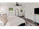Bright bedroom with large windows, ceiling fan, dark wood floor, and neutral decor at 4101 Tipperary Pl, Charlotte, NC 28215