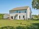 Backyard with fenced perimeter, grassy area, and exterior of the home at 4535 Falls Lake Sw Dr, Concord, NC 28025