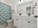 Well-lit bathroom featuring a double vanity, modern fixtures, and elegant patterned shower curtain at 4535 Falls Lake Sw Dr, Concord, NC 28025