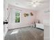 Charming bedroom featuring a gray carpet, natural light, and decorative touches at 4535 Falls Lake Sw Dr, Concord, NC 28025