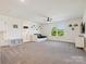 Spacious bonus room with daybed, ceiling fan, and plenty of natural light at 4535 Falls Lake Sw Dr, Concord, NC 28025