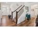 Welcoming foyer with wood floors, a staircase with wood railings, and stylish decor at 4535 Falls Lake Sw Dr, Concord, NC 28025