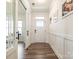 Bright hallway with wood floors, detailed trim work, and white paneled doors at 4535 Falls Lake Sw Dr, Concord, NC 28025