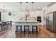 Kitchen with island, seating, stainless appliances, and white cabinets at 4535 Falls Lake Sw Dr, Concord, NC 28025