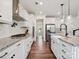 Modern kitchen with a stainless steel hood vent, granite counters, and stainless appliances at 4535 Falls Lake Sw Dr, Concord, NC 28025