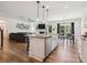 Open kitchen featuring an island, granite countertops, stainless steel appliances, and hardwood floors at 4535 Falls Lake Sw Dr, Concord, NC 28025
