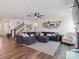 Comfortable living room with a large sectional sofa, ceiling fan, and a wall of Gathering photos at 4535 Falls Lake Sw Dr, Concord, NC 28025