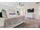 Bright main bedroom with neutral tones, a ceiling fan, and a view of the outdoors at 4535 Falls Lake Sw Dr, Concord, NC 28025