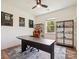 Bright office features a large desk, comfortable chair, and modern shelving for storage and display at 4535 Falls Lake Sw Dr, Concord, NC 28025
