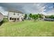 Expansive backyard featuring a patio, lush lawn, and secure black metal fencing surrounding the property at 505 Silers Bald Dr, Fort Mill, SC 29715