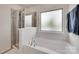 Bright bathroom with a garden tub, tiled shower, and window letting in natural light at 505 Silers Bald Dr, Fort Mill, SC 29715