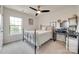 Bedroom with a decorative metal bed frame, ceiling fan, and desk with computer setup at 505 Silers Bald Dr, Fort Mill, SC 29715