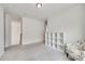 Empty bedroom with a white bookshelf next to a floral chair at 505 Silers Bald Dr, Fort Mill, SC 29715