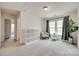 Bright bedroom with carpet, a floral chair, and multiple windows with green curtains at 505 Silers Bald Dr, Fort Mill, SC 29715