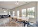 Bright dining area features a long wooden table and large windows offering views of the backyard at 505 Silers Bald Dr, Fort Mill, SC 29715