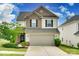Charming two-story home featuring a two-car garage, landscaped yard, and mixed siding at 505 Silers Bald Dr, Fort Mill, SC 29715