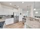 Well-lit kitchen boasts white cabinets, stainless steel appliances, and granite countertops at 505 Silers Bald Dr, Fort Mill, SC 29715