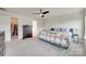 Spacious bedroom featuring a large bed, ceiling fan, and walk-in closet at 505 Silers Bald Dr, Fort Mill, SC 29715