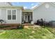 The covered back porch boasts comfortable seating and a ceiling fan for relaxed outdoor living at 6029 Phyliss Ln, Mint Hill, NC 28227