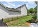 The backyard features a well-maintained lawn and a sleek black fence at 6029 Phyliss Ln, Mint Hill, NC 28227
