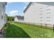 The backyard showcases a lush, green lawn and a modern black fence at 6029 Phyliss Ln, Mint Hill, NC 28227