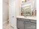 Clean bathroom featuring a framed mirror, neutral paint, and modern lighting fixtures at 6029 Phyliss Ln, Mint Hill, NC 28227